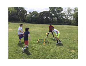 Four students playing spike ball 